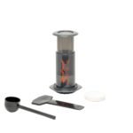 Badger & Dodo. Aeropress Starter Kit coffee maker includes a scoop, stirrer, and filter holder, shown on a white background.