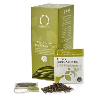 Badger and Dodo Coffee Roasters: A green box with white text showcases Solaris Teas Organic Jasmine Green, detailing the delightful tea inside. A clear sachet in front reveals aromatic loose green tea leaves.