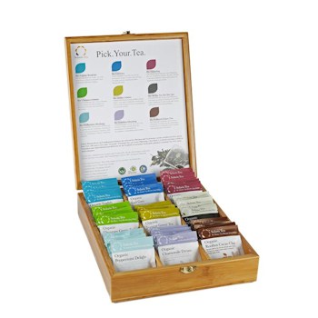 Badger and Dodo Coffee Roasters: The Filled Bamboo Gift Box is open, revealing vibrant tea packets neatly lined up. The inside lid displays a label with details of the diverse flavors ready for exploration.