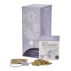 Badger and Dodo Coffee Roasters: The Organic Chamomile Dream box from Solaris Tea, elegantly purple and containing individual sachets, is showcased with a tea bag and loose organic chamomile leaves artfully displayed in front of it.