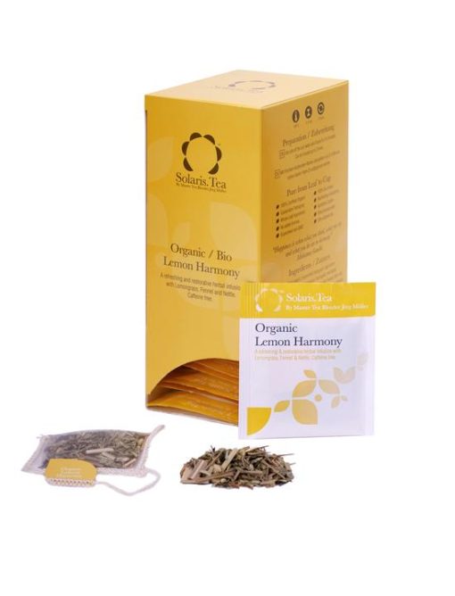 Badger and Dodo Coffee Roasters: A Solaris Tea box, labeled Organic Lemon Harmony, boasts a floral design. Inside, individually wrapped tea bags await, promising harmony. In front, a single bag is placed beside a pile of fragrant loose leaves.