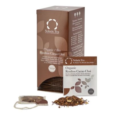 Badger and Dodo Coffee Roasters: A box of Organic Rooibos Cacao Chai is elegantly displayed with a teabag and loose rooibos leaves, while a labeled sachet is artfully placed in front.
