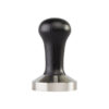 Badger and Dodo Coffee Roasters: The 58.4mm Precision Tamper, featuring a black ergonomic handle and flat stainless steel base, is essential for pressing coffee grounds in espresso preparation and is centered against a plain white background.
