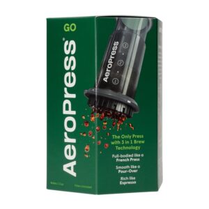 Badger & Dodo. Compact green box of the Aeropress Go Travel Kit, featuring an image of the coffee maker and coffee drops—an ideal travel companion with key features displayed on the front.
