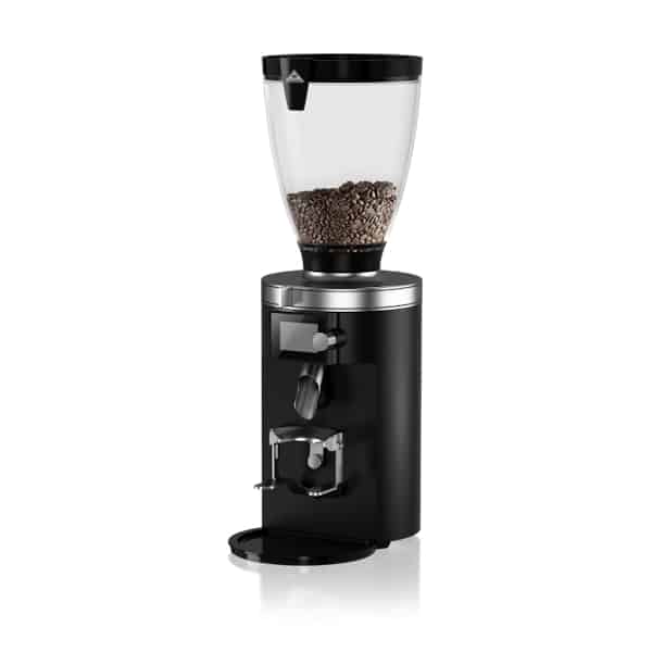 Badger and Dodo Coffee Roasters: The Mahlkonig E65 S is a sleek, black coffee grinder featuring a transparent bean hopper partially filled with coffee beans. Its stainless steel base and flat circular design add to its elegance, while the grind by weight function ensures precision in every cup.