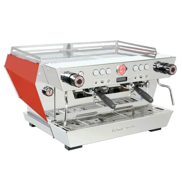 Badger and Dodo Coffee Roasters: The sleek KB90 espresso machine by La Marzocco features a dual-head design with stainless steel body and striking red side panels. Equipped with a pressure gauge, control knobs, and steam wands, it sits elegantly on its drip tray.