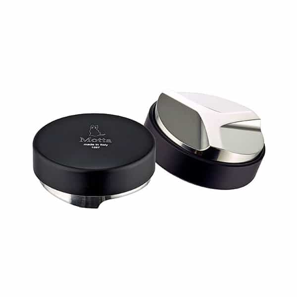 Badger and Dodo Coffee Roasters: Two stainless steel coffee tampers are shown, featuring sleek, modern designs. One boasts a black top with Motta and its logo, while the other displays its flat base. These precision tools pair perfectly with the Motta Distribution Tool for optimal espresso preparation.