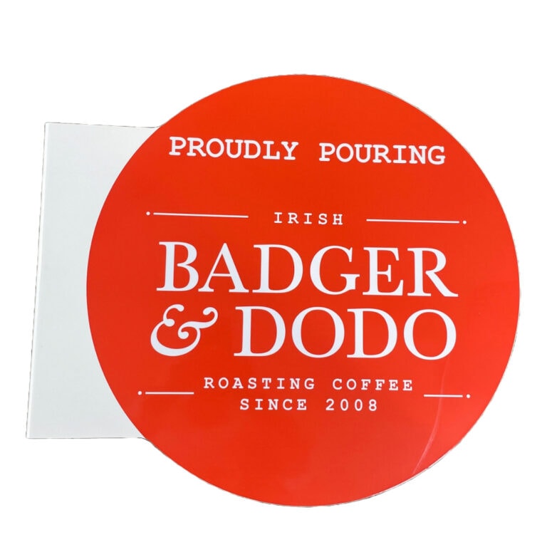 Badger & Dodo. Red circular double sided sign with “Proudly Pouring Irish Badger & Dodo Roasting Coffee Since 2008” in white text, perfect as an exterior wall projection sign.