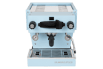 Badger & Dodo. The La Marzocco Linea Mini - Blue showcases dual pressure gauges, a steam wand, and a portafilter in its sleek light blue front-facing design.