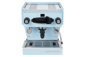 Badger & Dodo. The La Marzocco Linea Mini - Blue showcases dual pressure gauges, a steam wand, and a portafilter in its sleek light blue front-facing design.