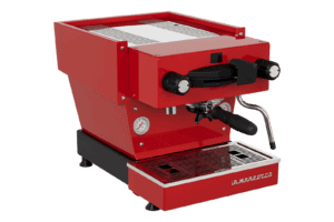 Badger & Dodo. A La Marzocco Linea Mini - Rossa stands out with its portafilter and steam wand against a crisp white background.