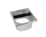 Badger and Dodo Coffee Roasters: The Open Knock Out Box is a square, stainless steel container featuring a circular opening and a black rod in the middle, ideal for disposing of used coffee grounds.