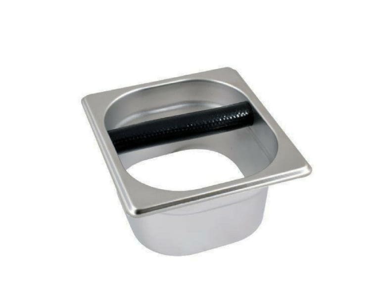 Badger and Dodo Coffee Roasters: The Open Knock Out Box is a square, stainless steel container featuring a circular opening and a black rod in the middle, ideal for disposing of used coffee grounds.