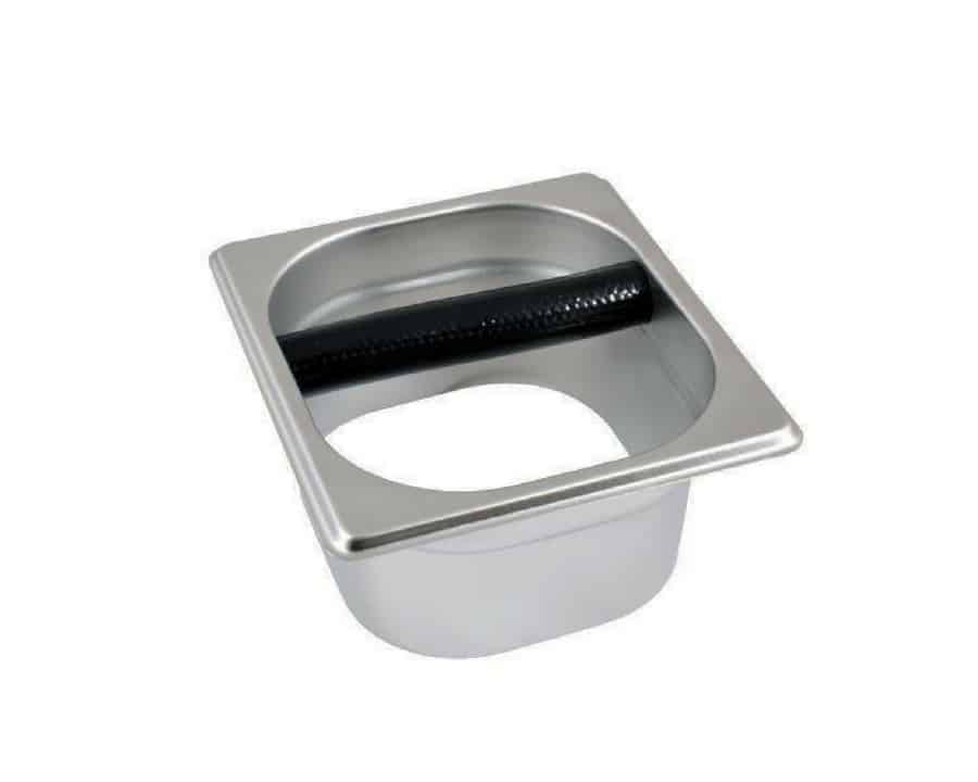Badger and Dodo Coffee Roasters: The Open Knock Out Box is a square, stainless steel container featuring a circular opening and a black rod in the middle, ideal for disposing of used coffee grounds.