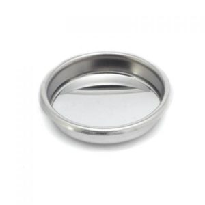 Badger and Dodo Coffee Roasters: A Blank Portafilter Basket 58mm with a round stainless steel design, featuring a raised edge and tilted base for drainage, resembling vst interface controls. The basket is empty and set against a white background.