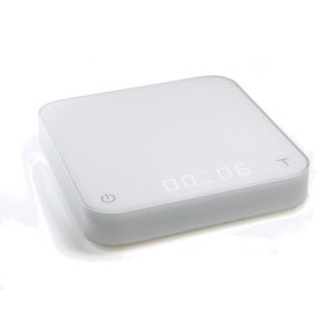 Badger and Dodo Coffee Roasters: Meet the Acaia Pearl - White (2021), a chic and minimalist digital kitchen scale with a rectangular design. It showcases an illuminated 00:06 display and touch-sensitive power and tare buttons, merging style with functionality seamlessly.