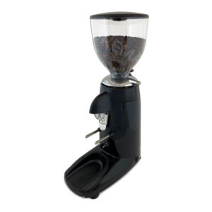 Badger and Dodo Coffee Roasters: The Compak K3 Touch, a stylish black grinder, has a clear hopper filled with beans and features a handy dispensing chute. It sits on a black base with an integrated tray for grounds, all elegantly placed on a clean white surface.