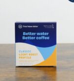 Box of Third Wave Water Classic Light Roast Profile mineral packets on a wooden surface, labeled “Better water, better coffee.”