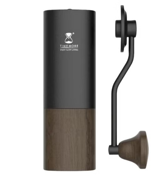 Black and wood Timemore manual coffee grinder with a side-mounted crank handle, shown against a white background. Black and wood Timemore manual coffee grinder with a side-mounted crank handle, shown against a white background.